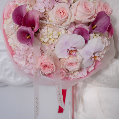 Close-up of blush garden roses, purple calla lilies, pink hydrangeas, lavender orchid and pearl strand detail with AMEROSE ribbon — luxury romantic bouquet London
